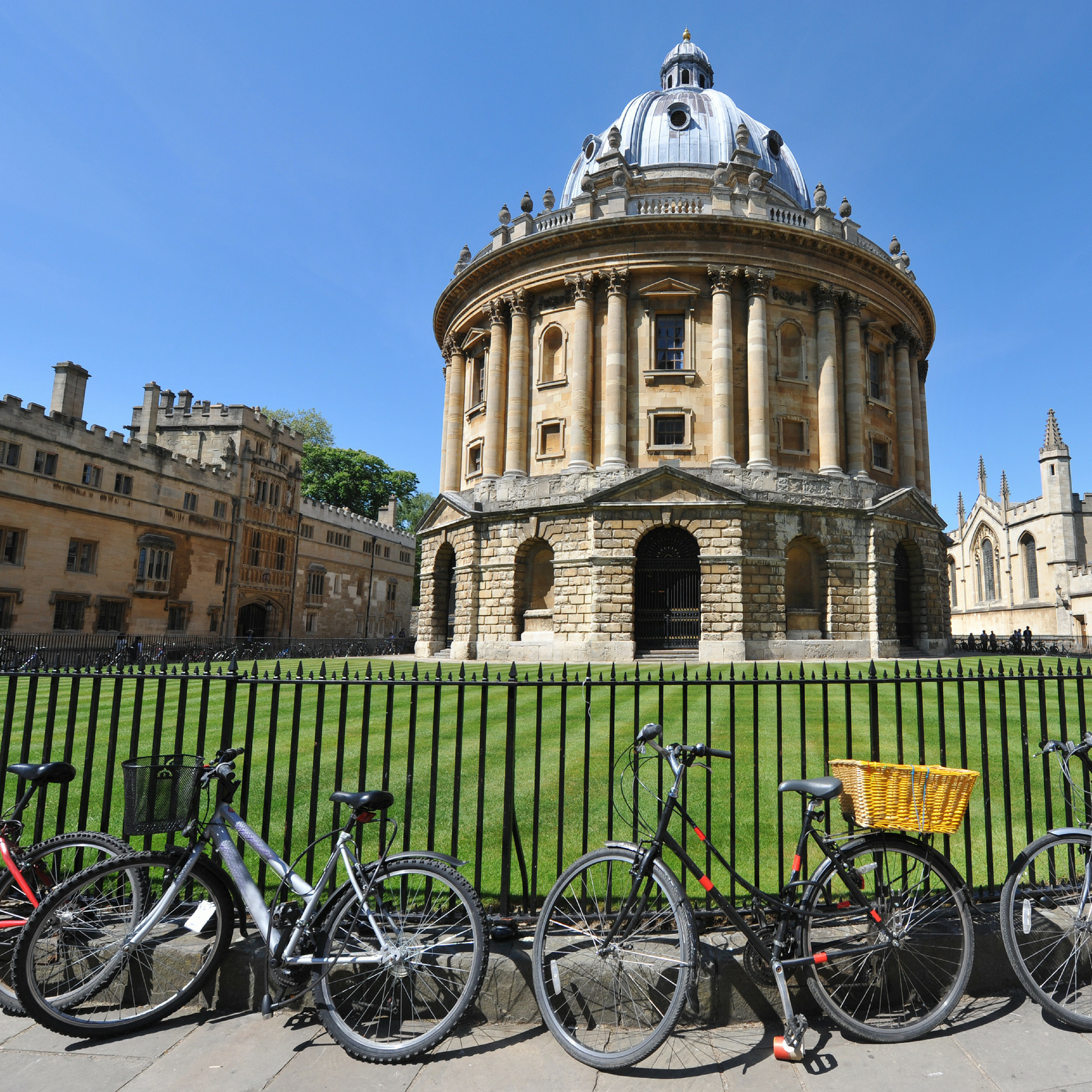 Oxford Camera building with a black railing in the foregound with bikes lent against the railing. 