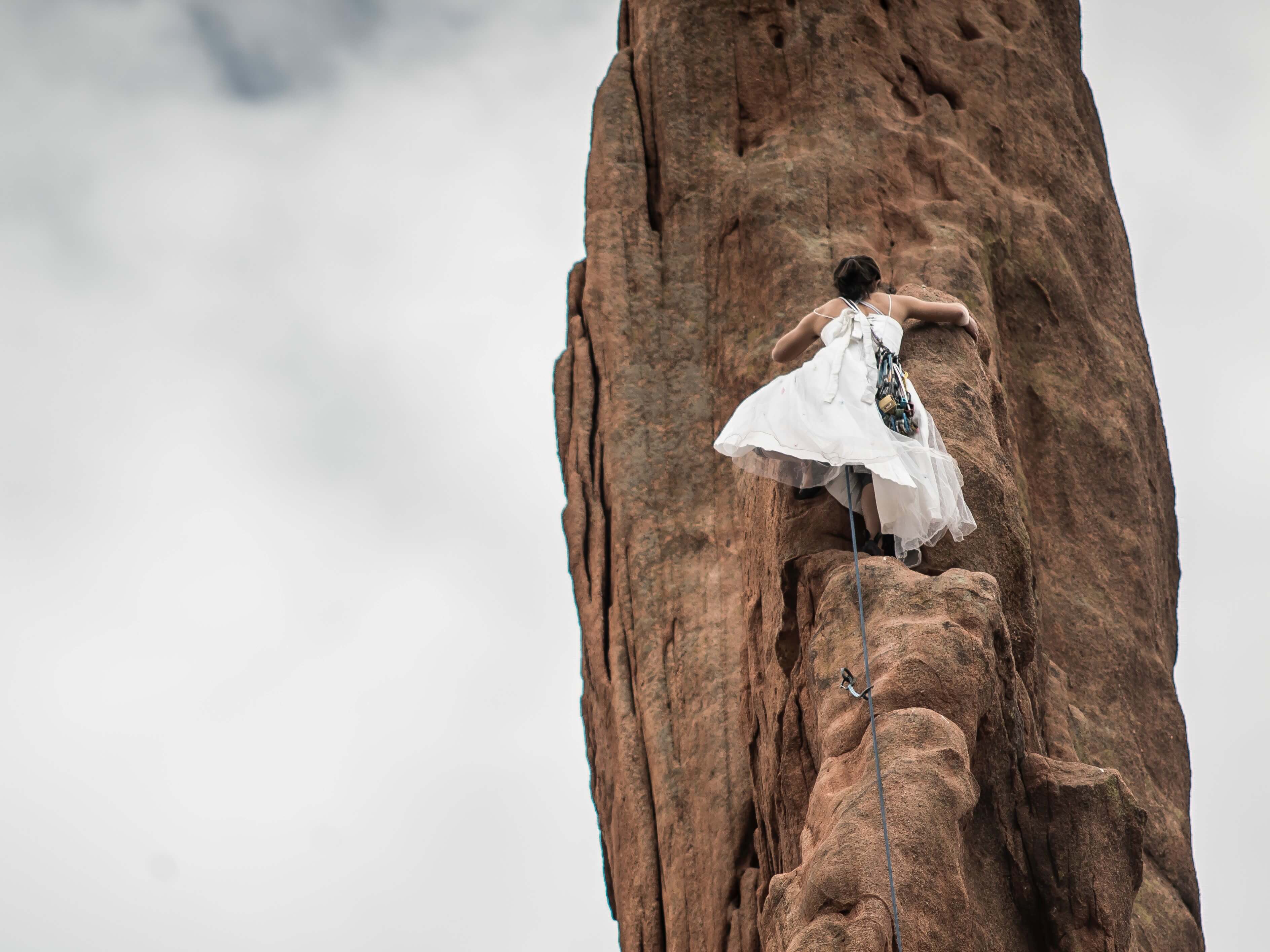 woman climbing on a high rock