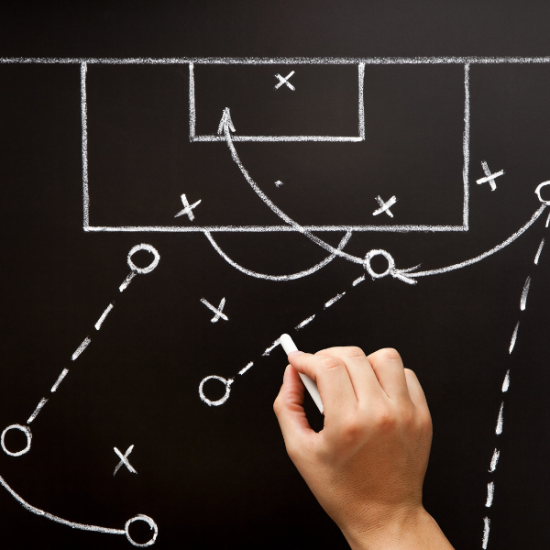 hand writing on chalk board with football tactics