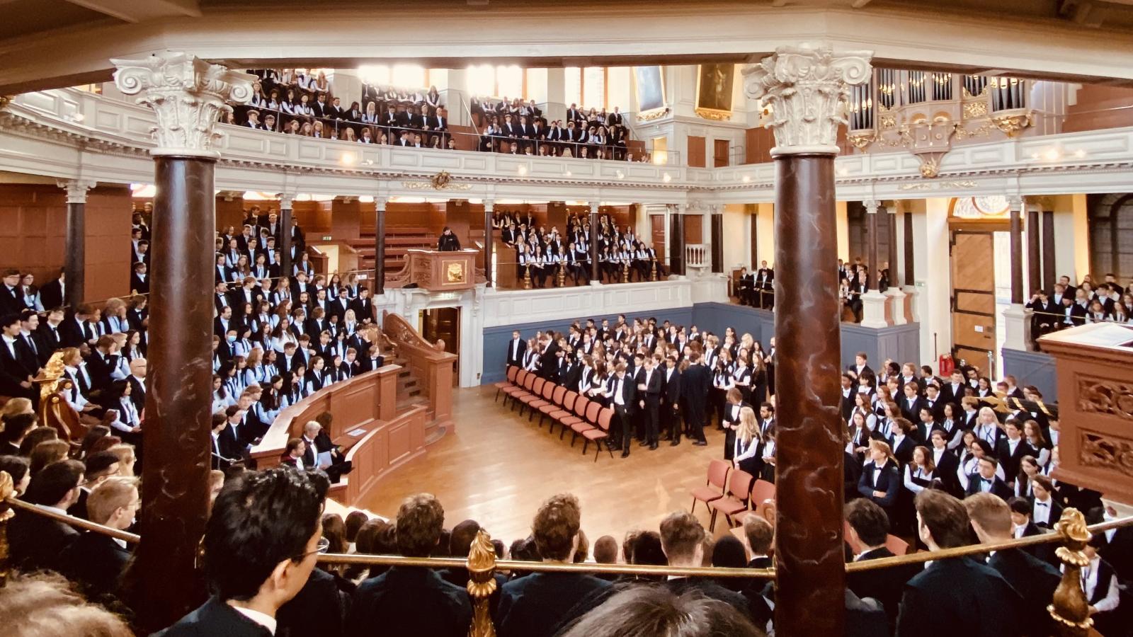 Students seated in the Sheldonian theatre, all wearing sub fusc