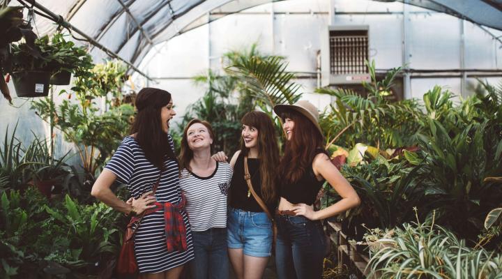 women laughing in greenhouse